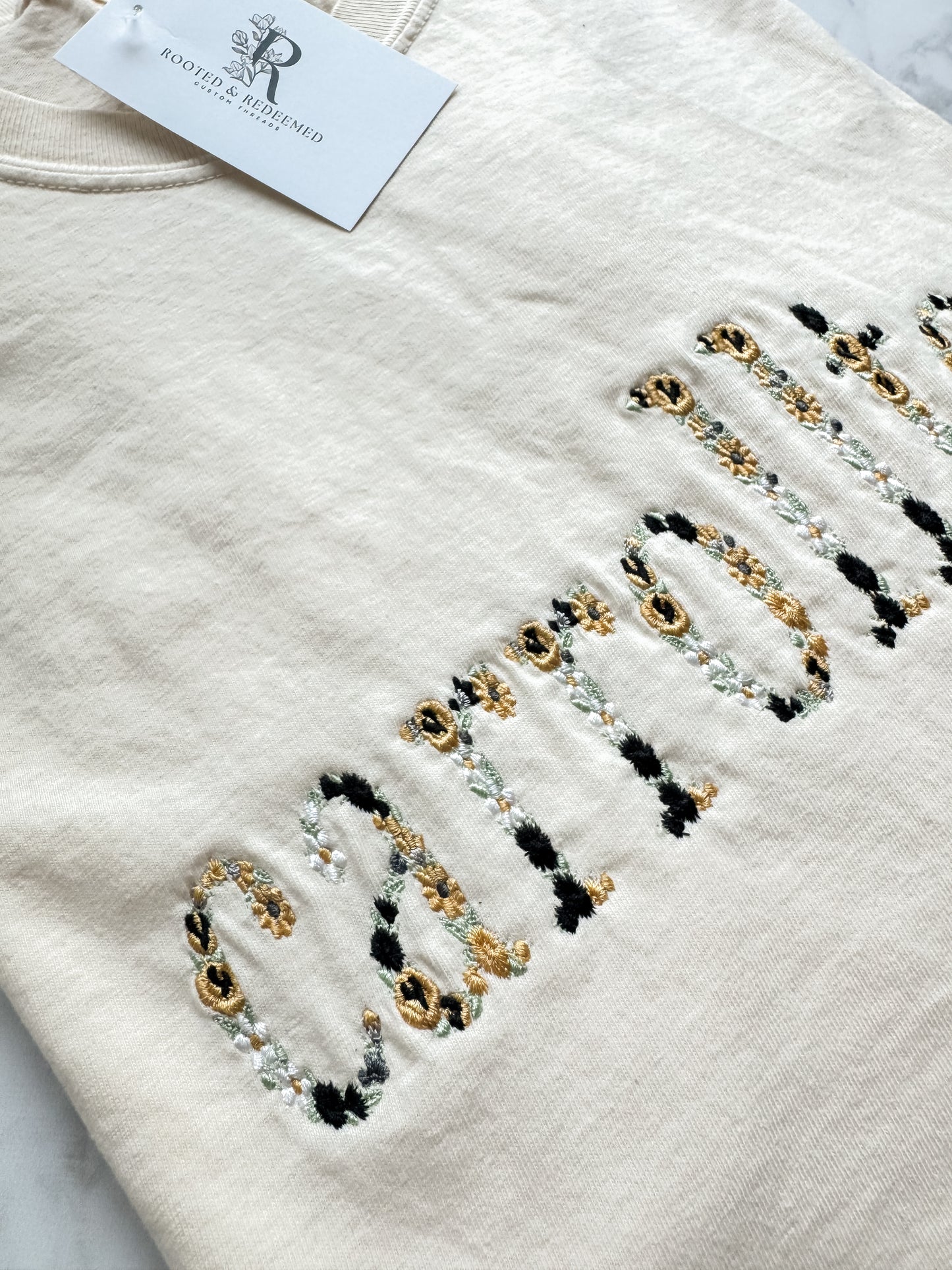 Carrollton Black and Gold Floral Letter Embroidered Comfort Colors T Shirt