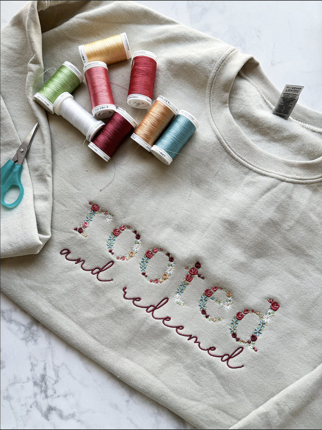 Rooted and Redeemed Floral Letter Embroidered Sweatshirt